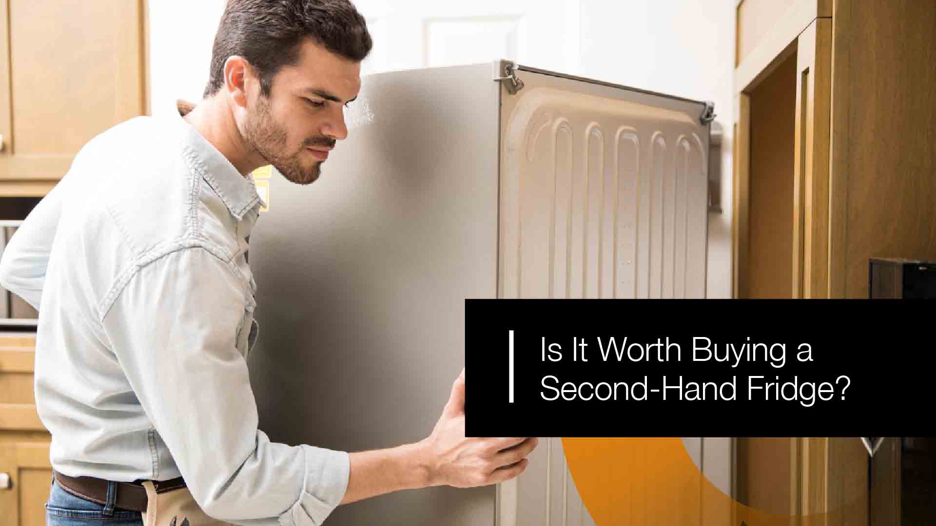 Second-hand refrigerator being inspected before purchase for quality and performance.